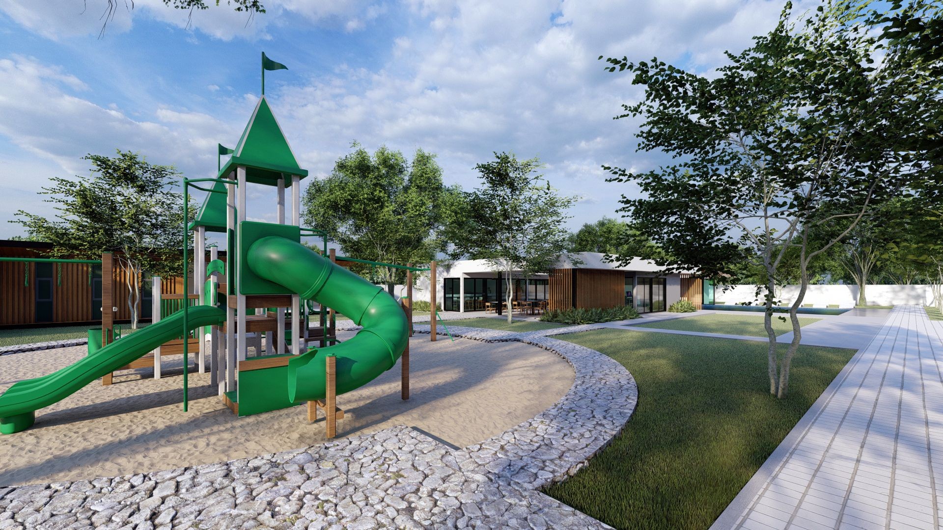 Outdoor playground with green slides and climbing structures surrounded by trees and modern building in the background.